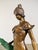 A refined bronze sculpture inspired by classical depictions of Diana, this piece presents a standing female figure...