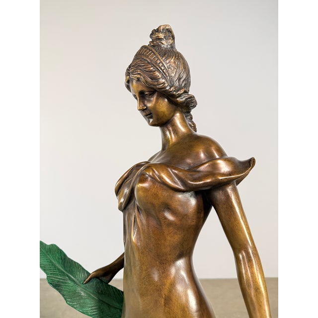 A refined bronze sculpture inspired by classical depictions of Diana, this piece presents a standing female figure...