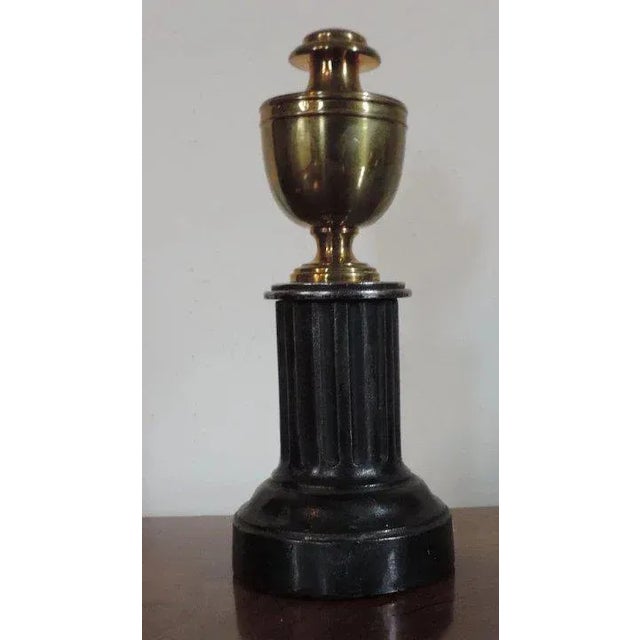 Antique early 19th century English regency mantle ornament in the form of a neoclassical brass urn atop a fluted steel...