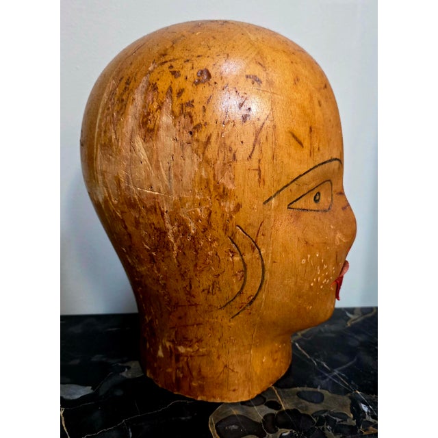 This antique millinery balsa wood hat store display head is a unique and handmade collectible piece. The intricate...