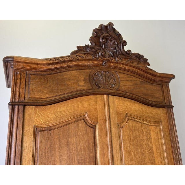 An elegant Antique French wardrobe crafted in Oak, featuring a tall, refined form with beautifully carved detailing,...