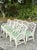 Enhance your dining space with this stunning set of eight vintage coastal Chinese Chippendale rattan dining chairs....