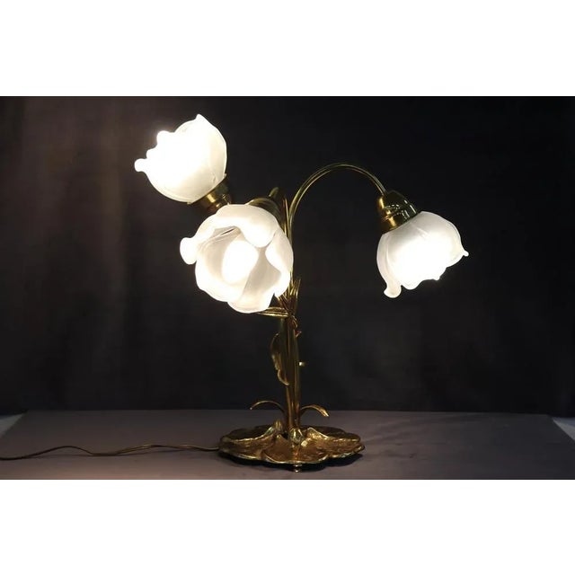 Beautiful Italian Art Nouveau style table lamp circa 1980s. Three light bulbs. The body is in refined golden brass, the...