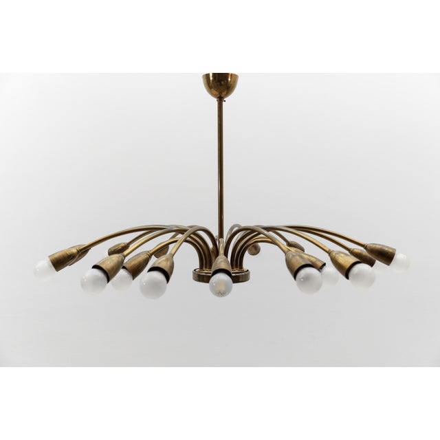 Executed in brass and metal. The lamp needs 18 x e14 / e15 edison screw fit bulb, is wired, in working condition and runs...