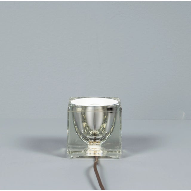 Peill & Putzler solid glass table lamp from the 1970s. Outside the cube has a smooth, clear surface, the inside is a white...