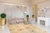 A handwoven wool flatweave, made in India and measuring 5'6"' x 10'. Floral drawing carried across the field inside a...