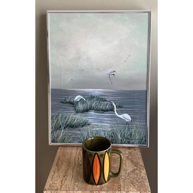 Charming vintage Florida painting featuring marshes and birds. Oil on canvas measures 12 1/2” x 16 1/2”, including the...
