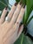 A 0.69-carat padparadscha sapphire oval sits at the centre of this solid 14K yellow gold ring, framed by eight earth-mined...