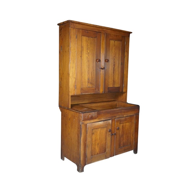 This 19th-century antique oak stepback hutch is a classic example of American primitive country craftsmanship, showing an...