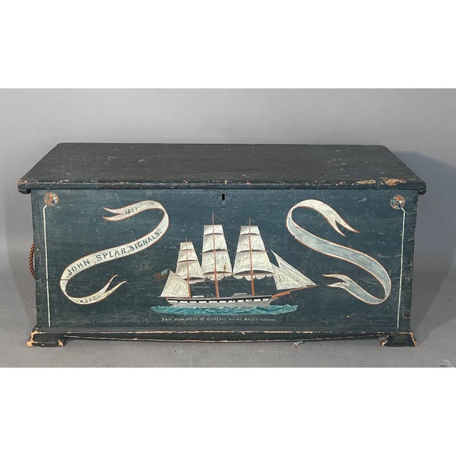 A striking 19th-century American hand-painted pine sea chest featuring a wonderfully graphic maritime scene. The front is...