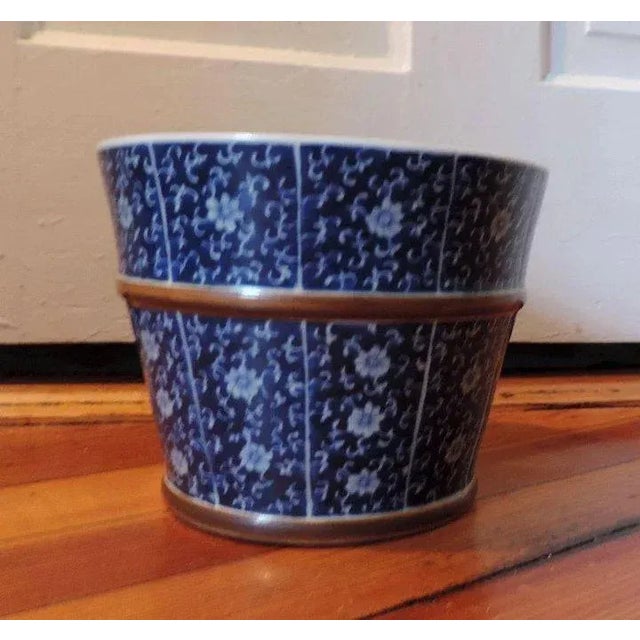 Finely decorated 19th c. Chinese blue and white porcelain planter urn in the form of a barrel with brown glazed hoops and...