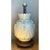 This vintage table lamp is a substantial, sculptural form built around a bulbous ceramic body, glazed in a soft celadon-...