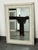 Design Plus Gallery presents an Embossed Geometric Pattern Wall Mirror. Showcasing an off-white frame with distressed...