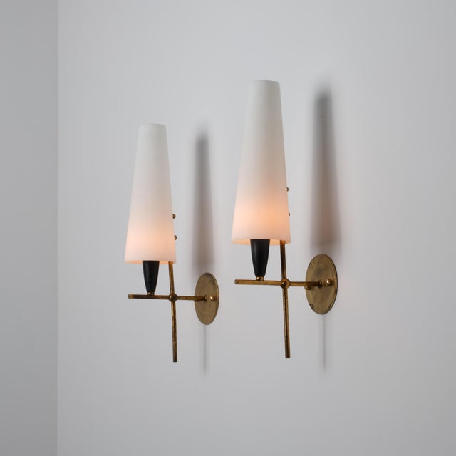 Refined pair of italian wall lights from the 1950s, characterized by a sculptural and well-balanced composition. each...