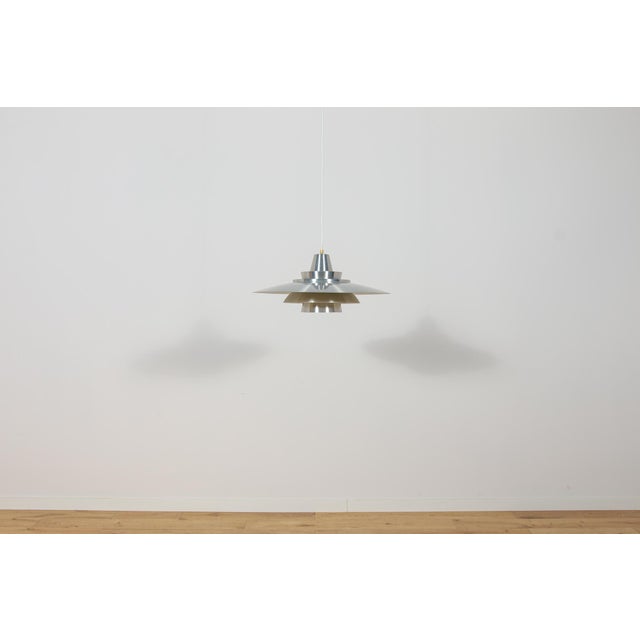 This large pendant lamp was designed by Mogens Davidsen for the Danish lighting manufacturer Superlight during the 1970s....