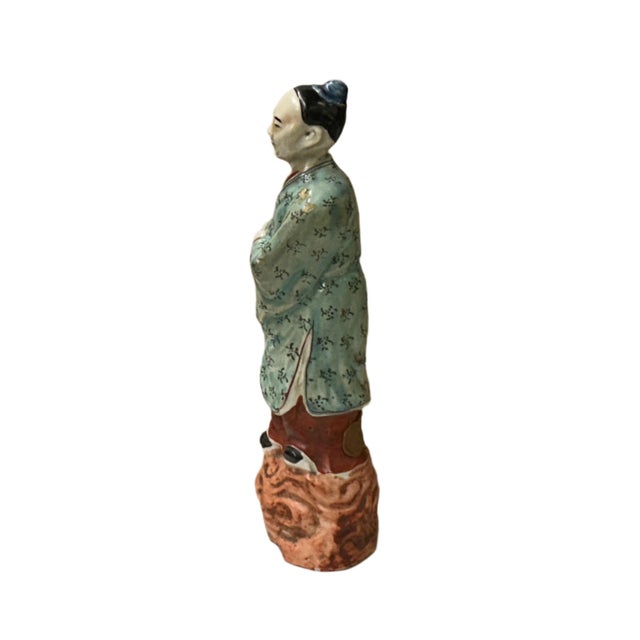 Discover the serene wisdom of this vintage Chinese porcelain figure, depicting a scholar or official in traditional...