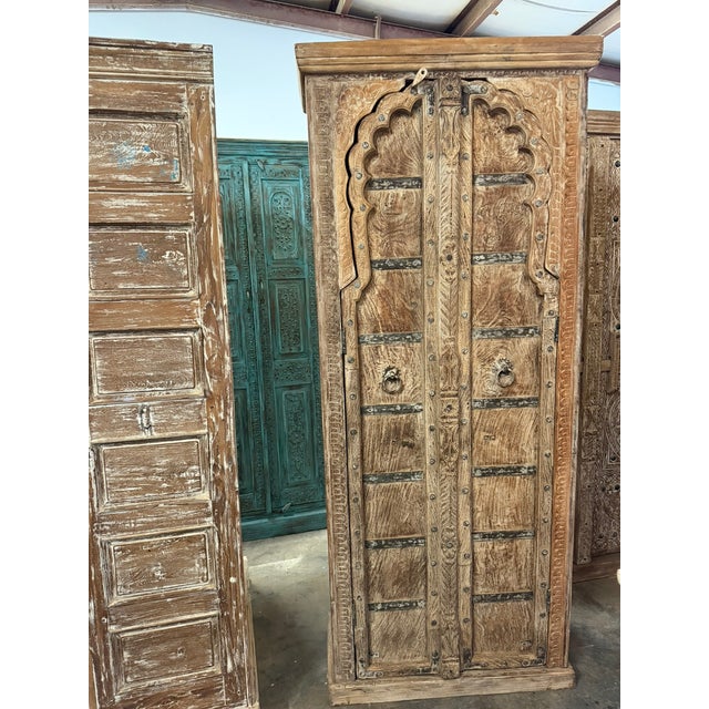Elevate your space with this vintage-inspired arched door cabinet, beautifully finished in a soft limewashed patina that...