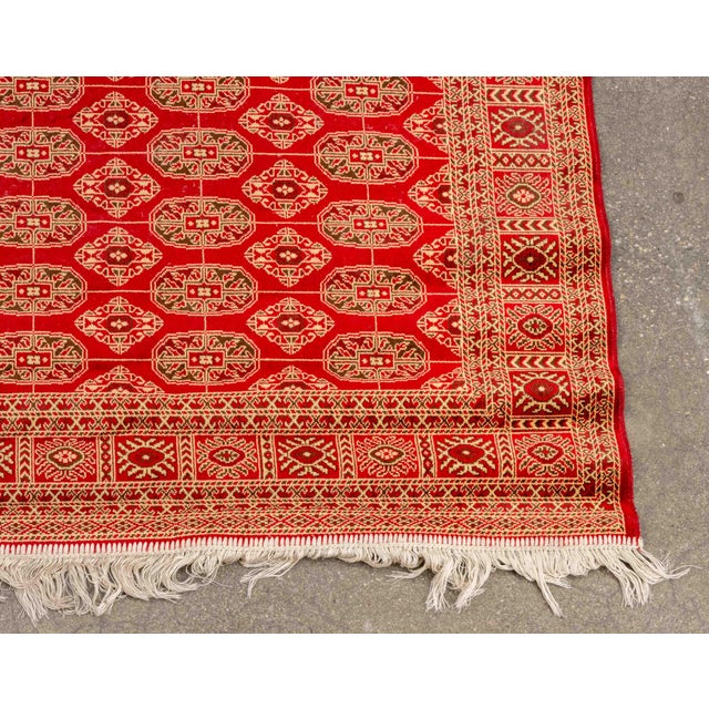 Persian Bokhara Silk and Wool Rug, on red ground with repeating geometric pattern. 6' 5" L x 4' 6" W. Provenance: From an...