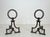 This beautiful pair of modernist andirons is made of wrought iron. It is a French work in the style of Gilbert Poillerat....
