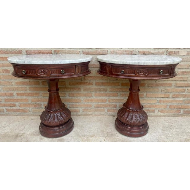 Pair of Carved Wood Demi Lune Side Tables or Nightstands with One Drawer and Marble Top. Pair of Demi Lune side tables or...