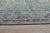 A hand-knotted silk rug, made in India and measuring 8' x 10'. Floral drawing carried across the field inside a...