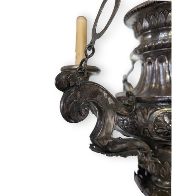 Silver plated copper Sanctuary style chandelier with brass angels holding the bobeches and candle cups. The canopy and the...