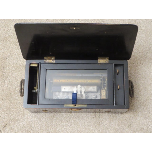 This small (13.5" x 7' x 5") antique Swiss cylinder music box displays beautifully with all the great patina that comes...