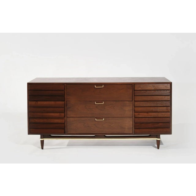 A meticulously restored mid-century modern walnut dresser by American of Martinsville. Crafted with exquisite attention to...