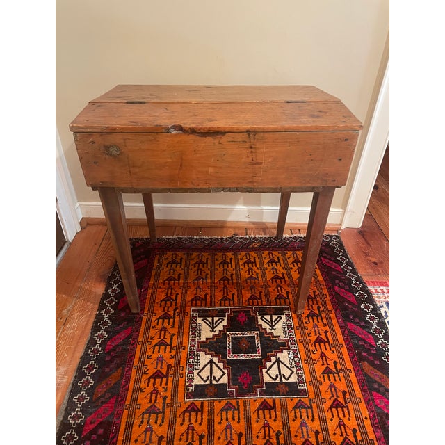 This rustic pine slant top writing desk features lovely old pine with a lovely, caramel patina. It has ample storage...