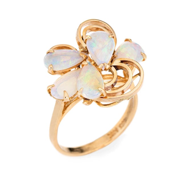 Stylish vintage opal ring (circa 1970s) crafted in 14 karat yellow gold. Five cabochon cut teardrop shaped opals measure...