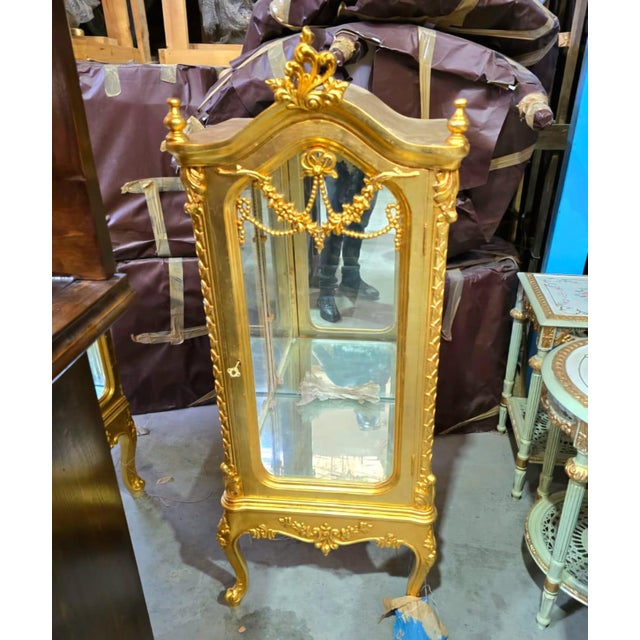 Showcase your most treasured collectibles in timeless French elegance with this exquisite Rococo-inspired curio display...