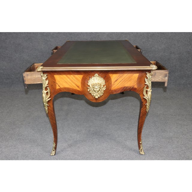 Dimensions: 29.5 inches (high) x 60 inches (wide) x 32.5 inches (deep) An elegant Louis XV style brass-mounted partners...