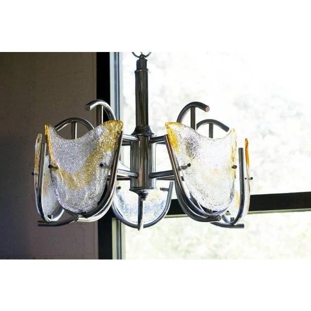 Mazzega chandelier, Italy, circa 1970. Six lights with "C" shaped arms holding handblown Murano glass panels. Textured...