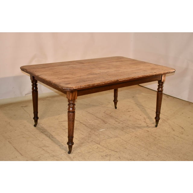 19th century Farm table from France with a scrubbed top that has gorgeous wear, color and graining. The top follows down...