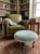 Elevate your space with this captivating vintage Hollywood Regency round footstool ottoman, beautifully upholstered in a...