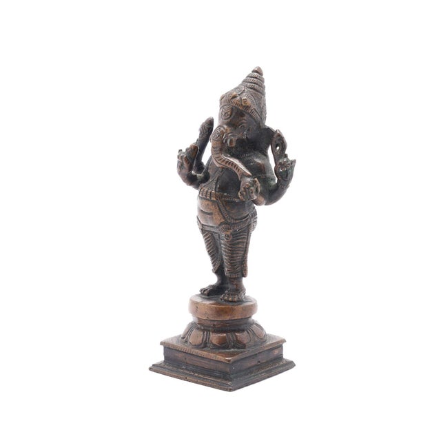 Lost wax bronze casting of a standing Ganesha on plinth with lotus throne. India, circa 1800's. Dimensions: 2-1/2" W x 2"...