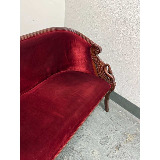 Design Plus Gallery presents a Victorian Carved Swan Settee. The settee is upholstered in red velvet, which follows the...