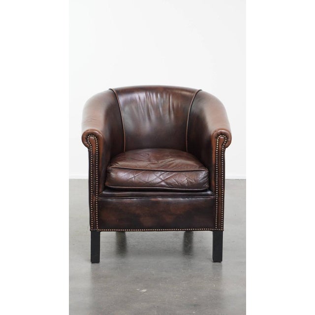 Offered this comfortable and elegant club chair in a beautiful dark color made of English style cowhide leather. This...