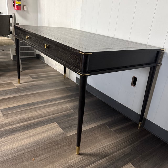 Elevate your workspace with the Arteriors Jobe Desk in Ebony, a distinguished writing desk that merges refined aesthetics...