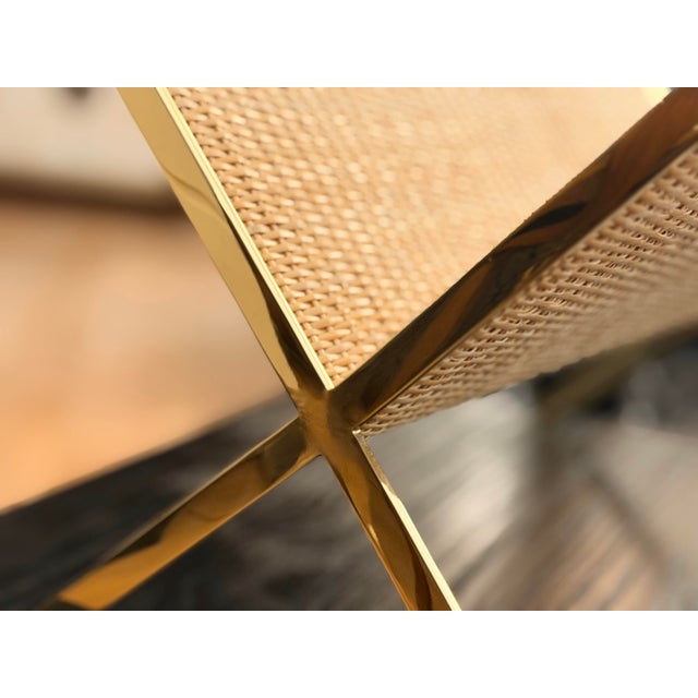 This stylish magazine rack is crafted from woven cane and brass and was inspired by bamboo and raffia designs from the...