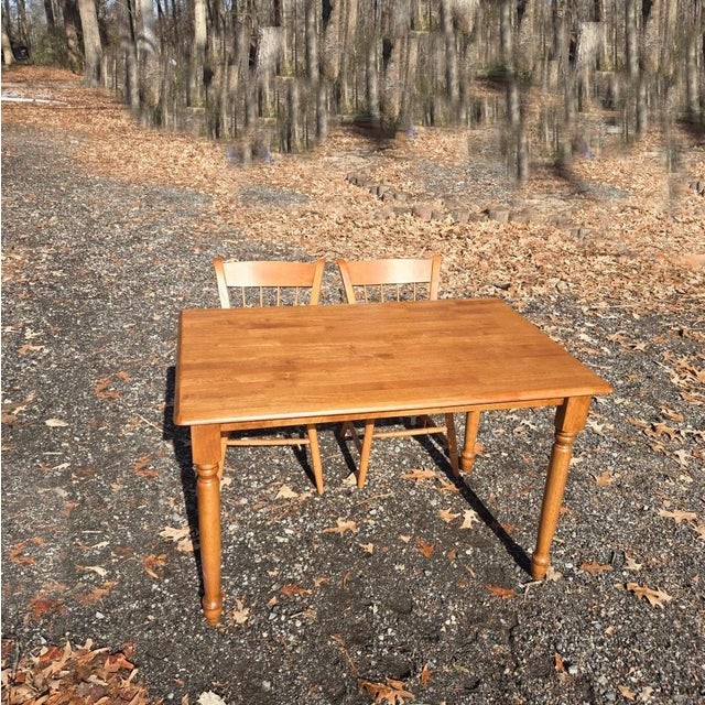 This chair and table set is exceptionally made. It has a light stain to complement its wood grain, and it features a...