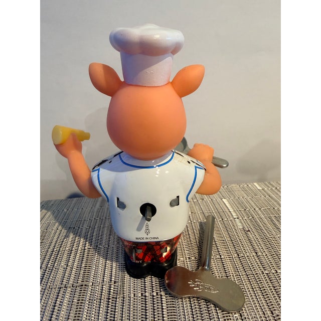 Add some whimsy to your collection with this adorable Mechanical Piggy Chef wind-up toy by Rocket USA. Released in 2004 as...