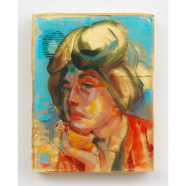 The artwork features a contemplative figure with a striking expression, enveloped in vibrant hues of gold and blue. The...