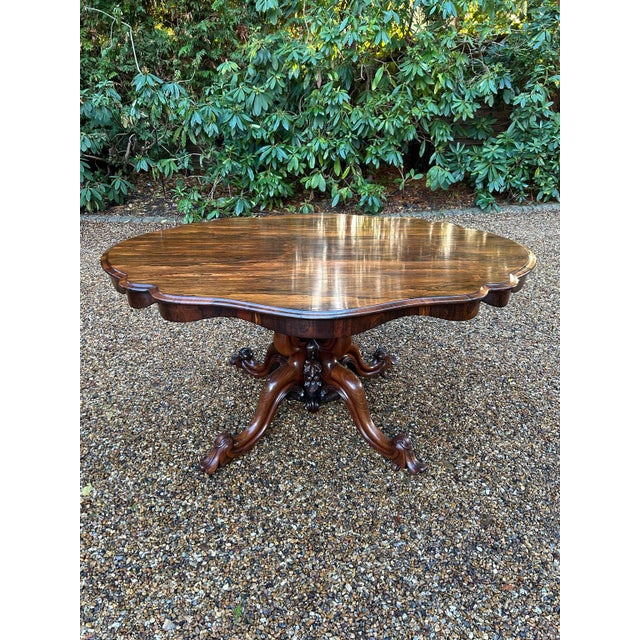 A very high quality William IV Rosewood Tilt-Top Oval Serpentine Dining Table / Centre Table with a shaped edge top above...