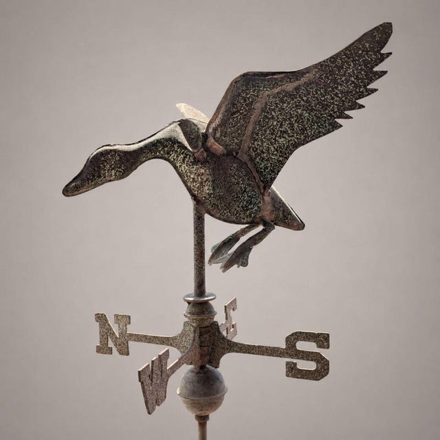 a rare copper weathervane from the early 1900s, featuring a three-dimensional composition depicting a duck with open...