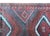 A wonderful mid-20th century Afghani Baluch rug with three large diamond medallions with stylized scrolling vine patterns...
