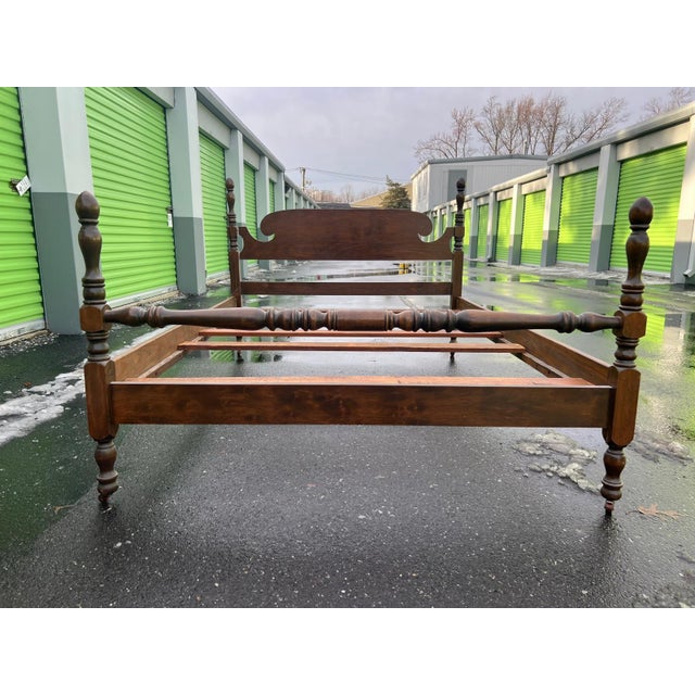 This vintage full-size bed frame is crafted from solid wood and features classic turned posts with traditional spindle...