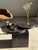 A brown petrified wood coffee table composed of three solid elements: a cubic base and two overlapping, offset circular...