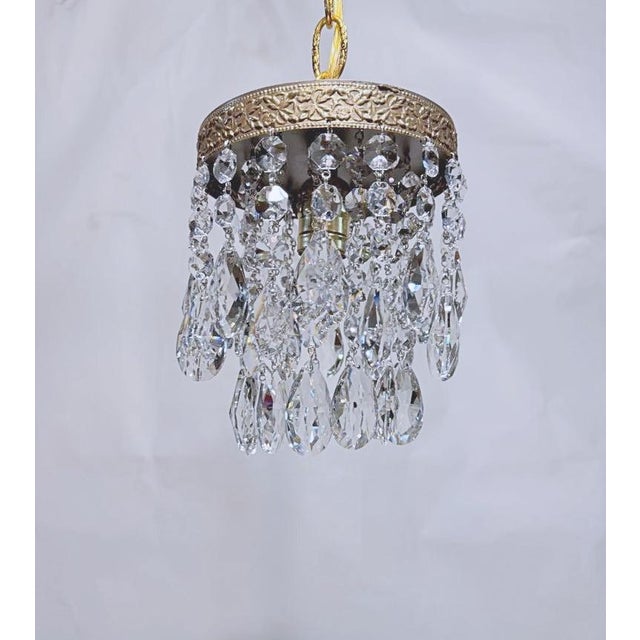 Italian layered chandelier with brass rim and 30% leaded Swedish cut crystal drops. It has 1 Edison base socket that holds...