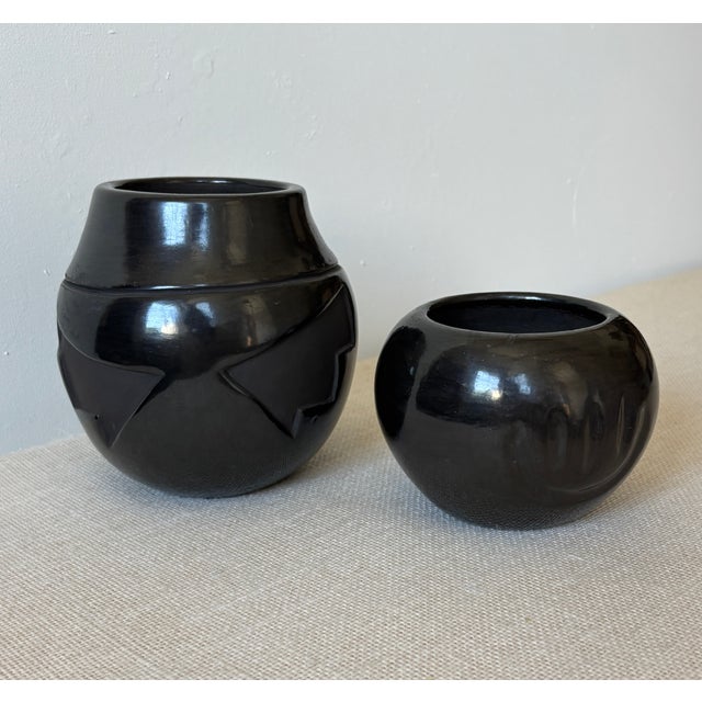 Set of 2, vintage Santa Clara Pueblo Blackware ceramic Pots or Vases in different shapes and with differing design...